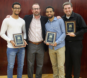 three students receiving leadership awards