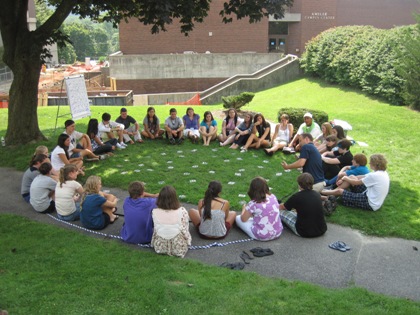 Group of students outside sitting in a circle