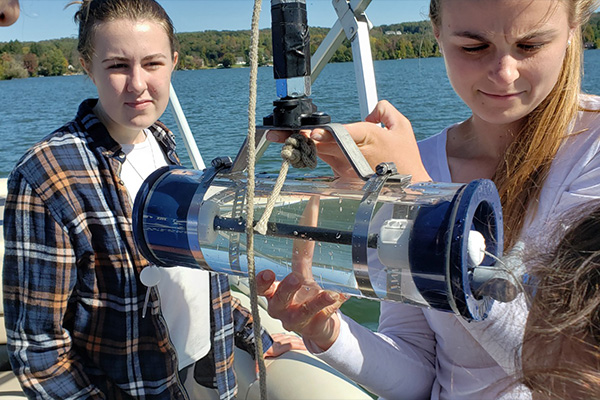 MCLA students working on a boat