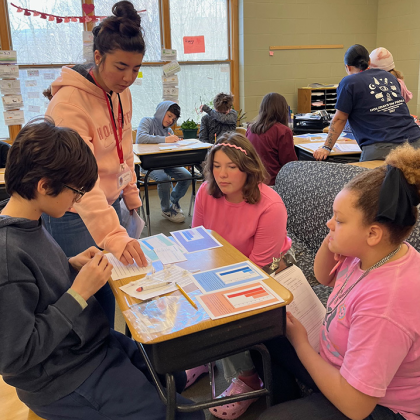 A PHCH student teaching a group of elementary school students.