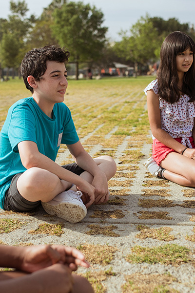 Children sitting on a field